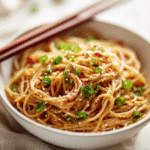 u3929625643 Garlic Sesame Noodles in a white bowl with chopst e5ff283f 80a4 4c01 97ff 77c2245998a0 0