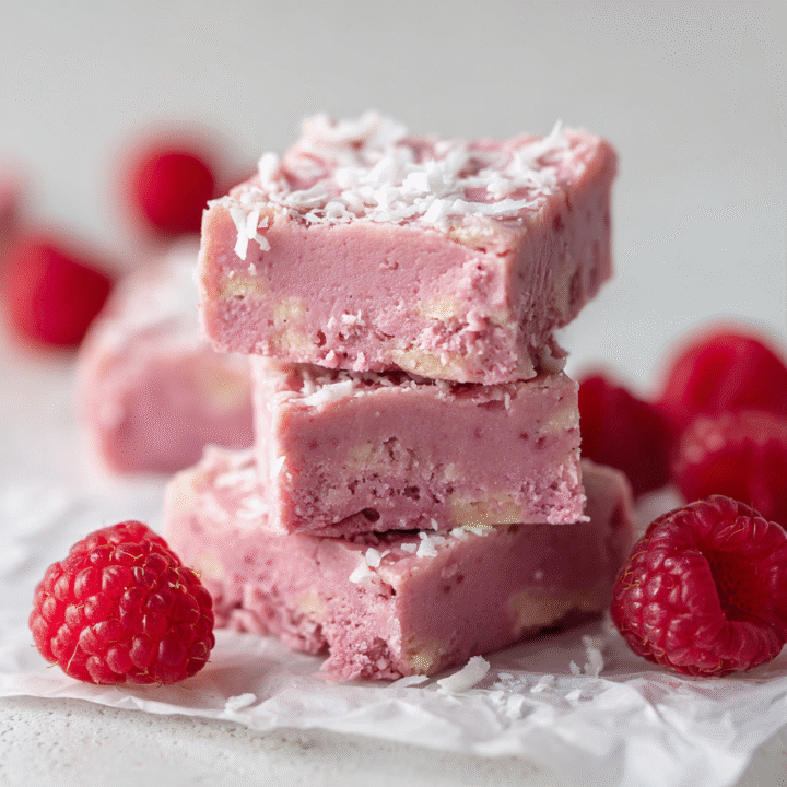 u3929625643 vegan raspberry coconut fudge squares on parchmen 122aaec4 d3a8 49fa b351 f0fe8bf07c17 3
